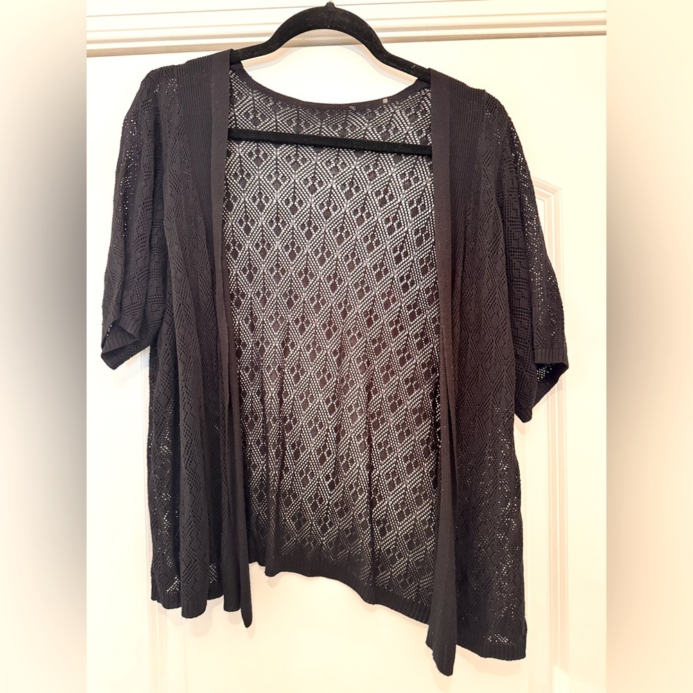 Dainty lace-like short sleeve sweater cardigan.